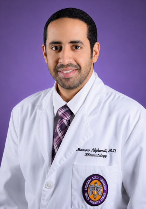 Professional headshot of a person wearing a white medical lab coat and a purple plaid tie, posed against a solid purple background. The coat features embroidered text identifying a rheumatology specialty and a Louisiana State University Health Sciences Center emblem on the front pocket. The subject is facing the camera in a studio-style portrait with even lighting.