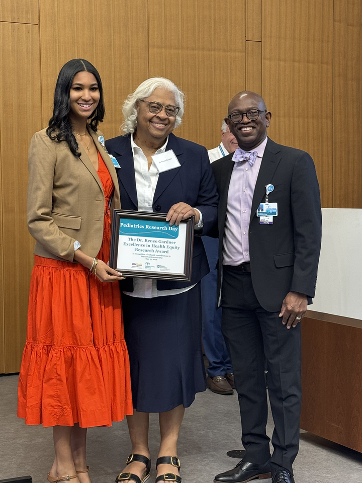 Dr. Gely accepts award