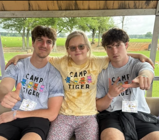 camper surrounded by camp counselors