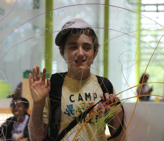 camper waves through glass wall