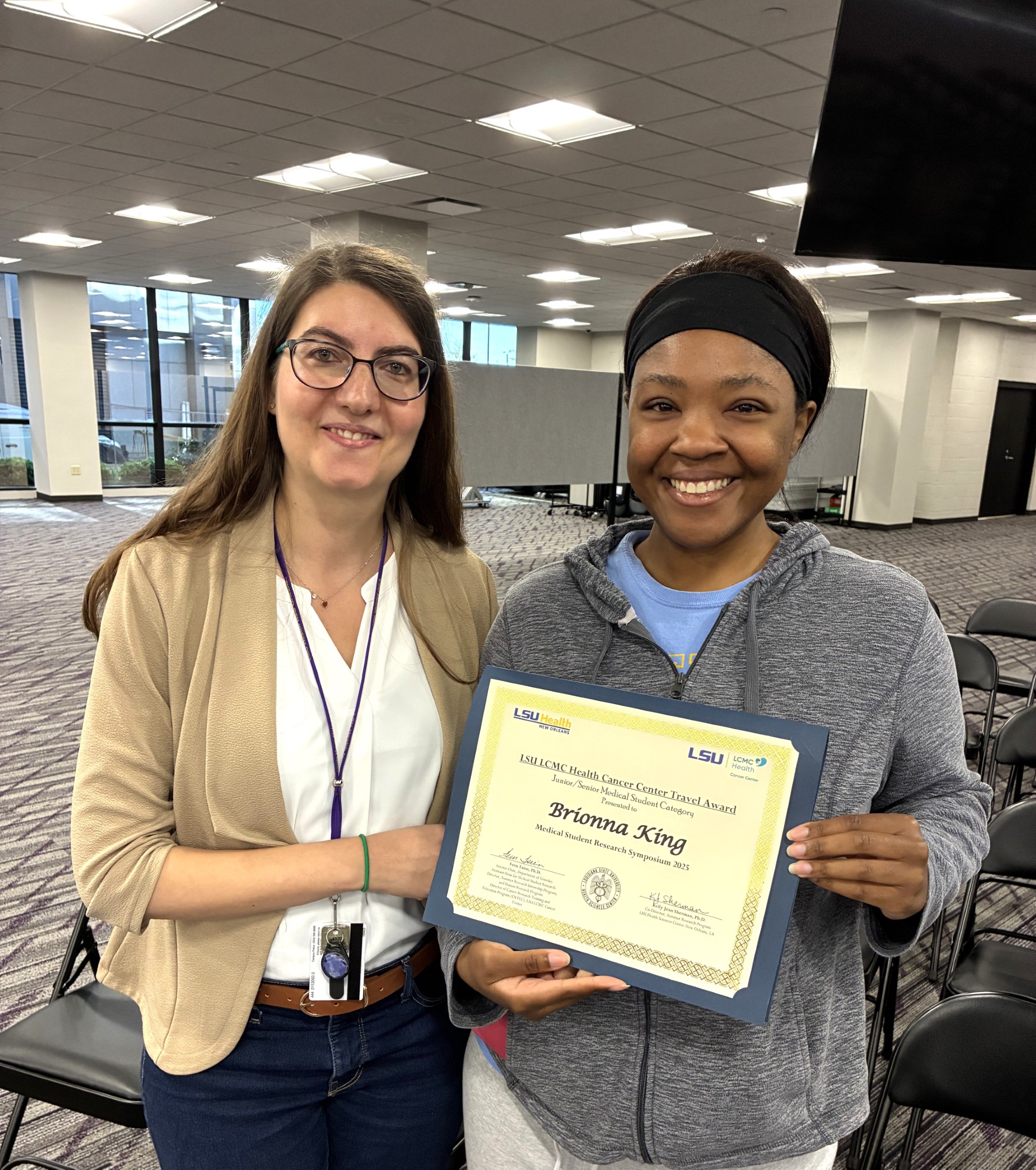 Brionna King with award certificate