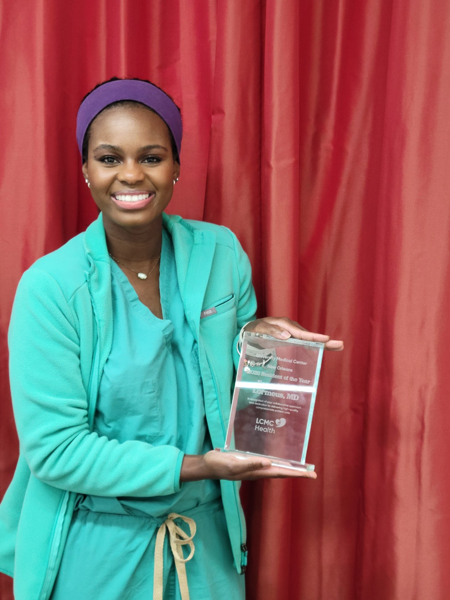Dr. Lormeus with award