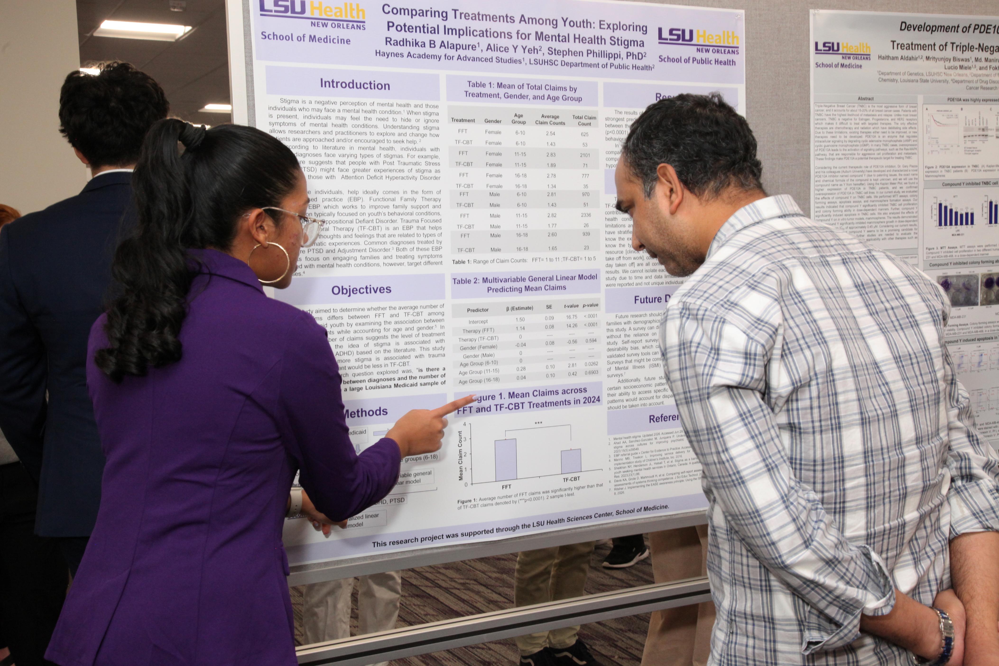 intern discusses her researcher with faculty member