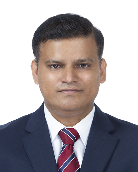 Professional head-and-shoulders portrait of a person wearing a dark blue suit jacket, white dress shirt, and red striped tie. The person is facing the camera against a plain light gray background. The image is evenly lit, cropped from the shoulders up, and presented in a formal business portrait style.