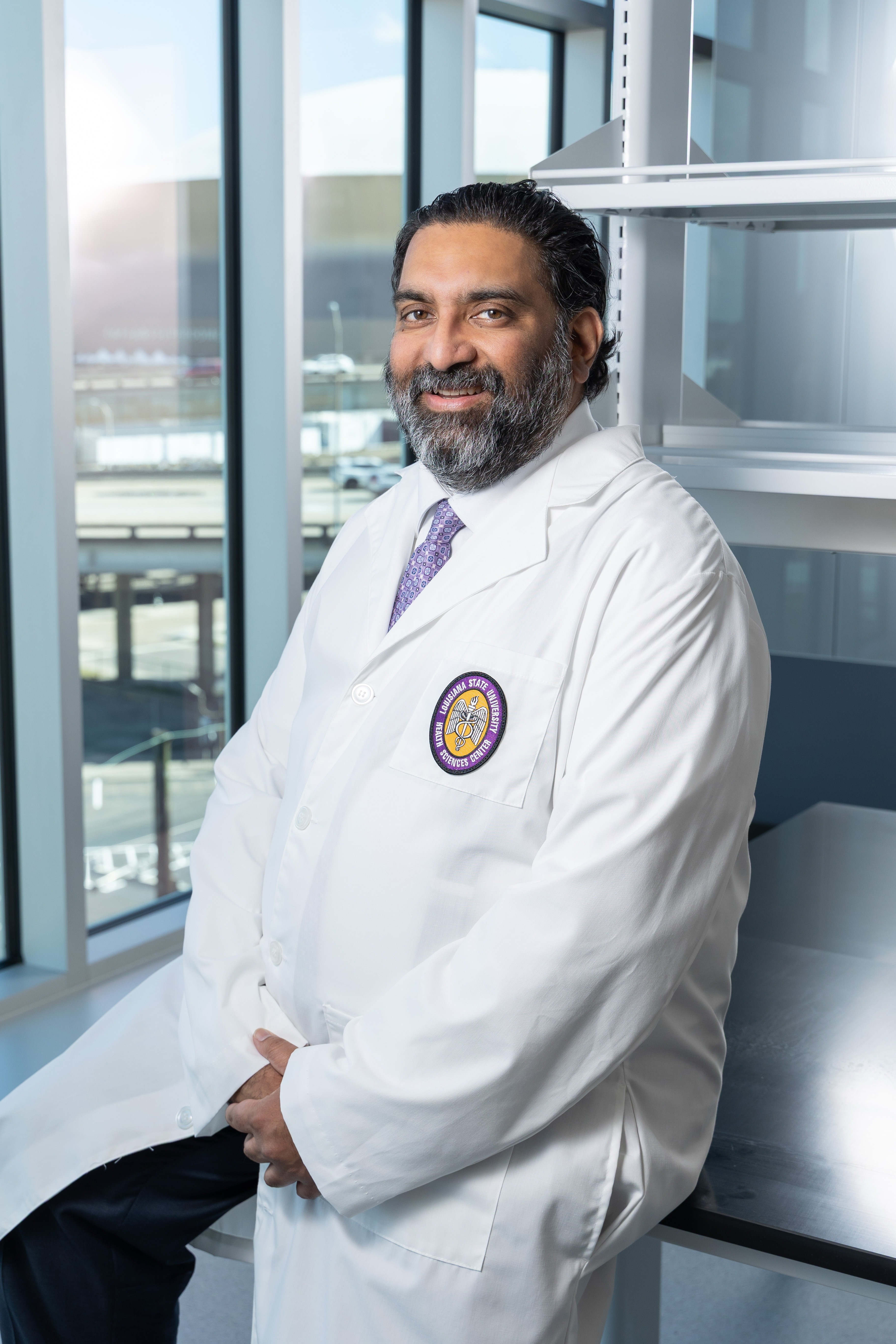 Dr. Puneeth Iyengar seated at Medical Education Building lab