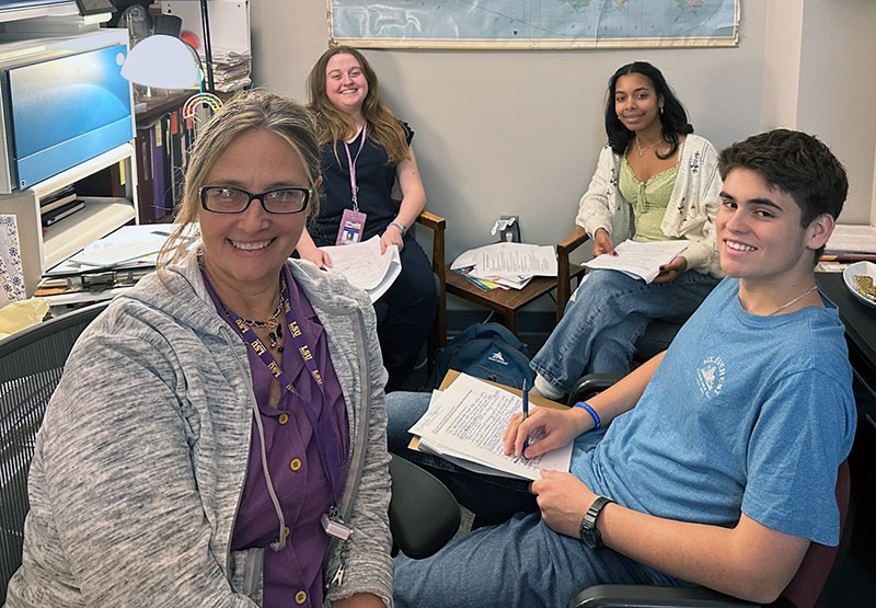 Summer interns Alexis and Elise collaborating with research staff at LSU LCMC Health Cancer Center.