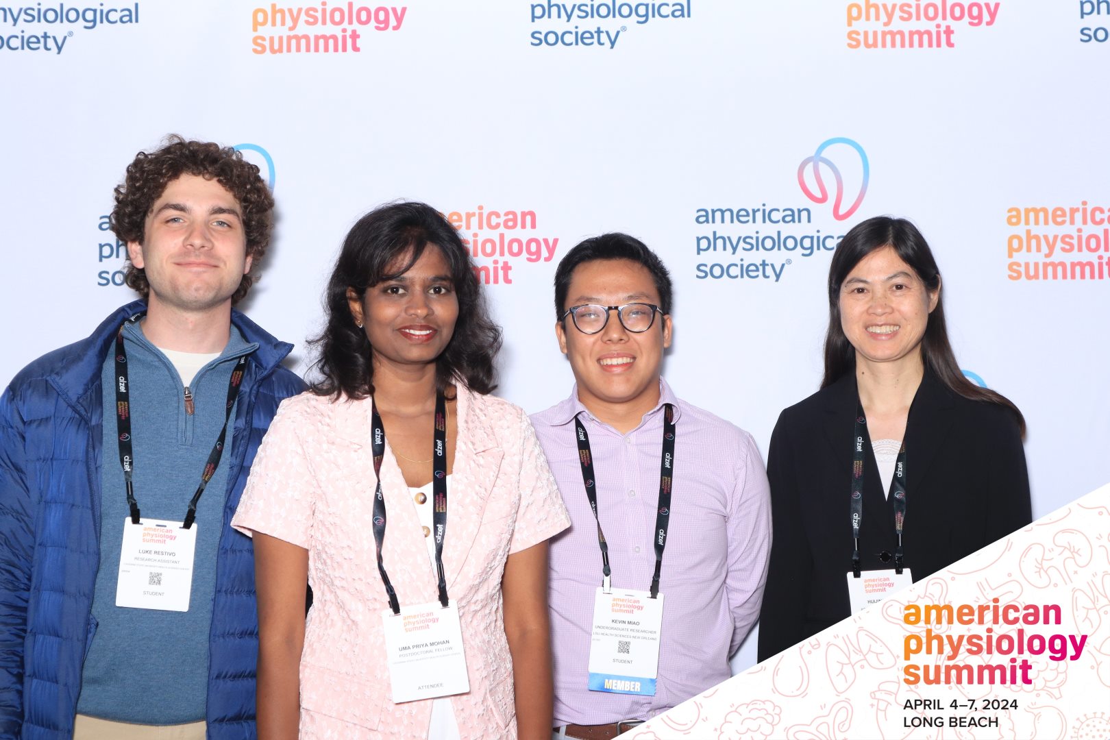 Luke, Uma, Kevin, and Huijing in front of an APS board