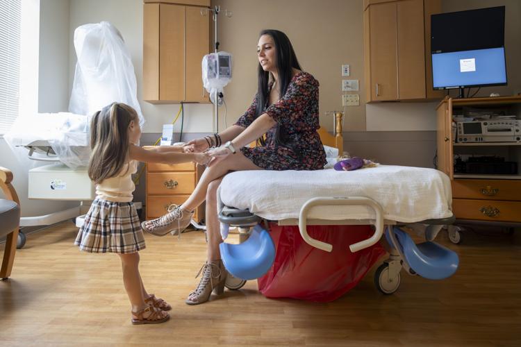 Rachel Hernandez with her daughter, Raedynn, 2, while waiting to see doctors at Our Lady of the Angels Hospital in Bogalusa 