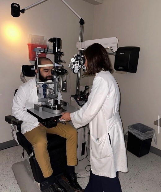 Dr. Reinoso demonstrates eye examination equipment