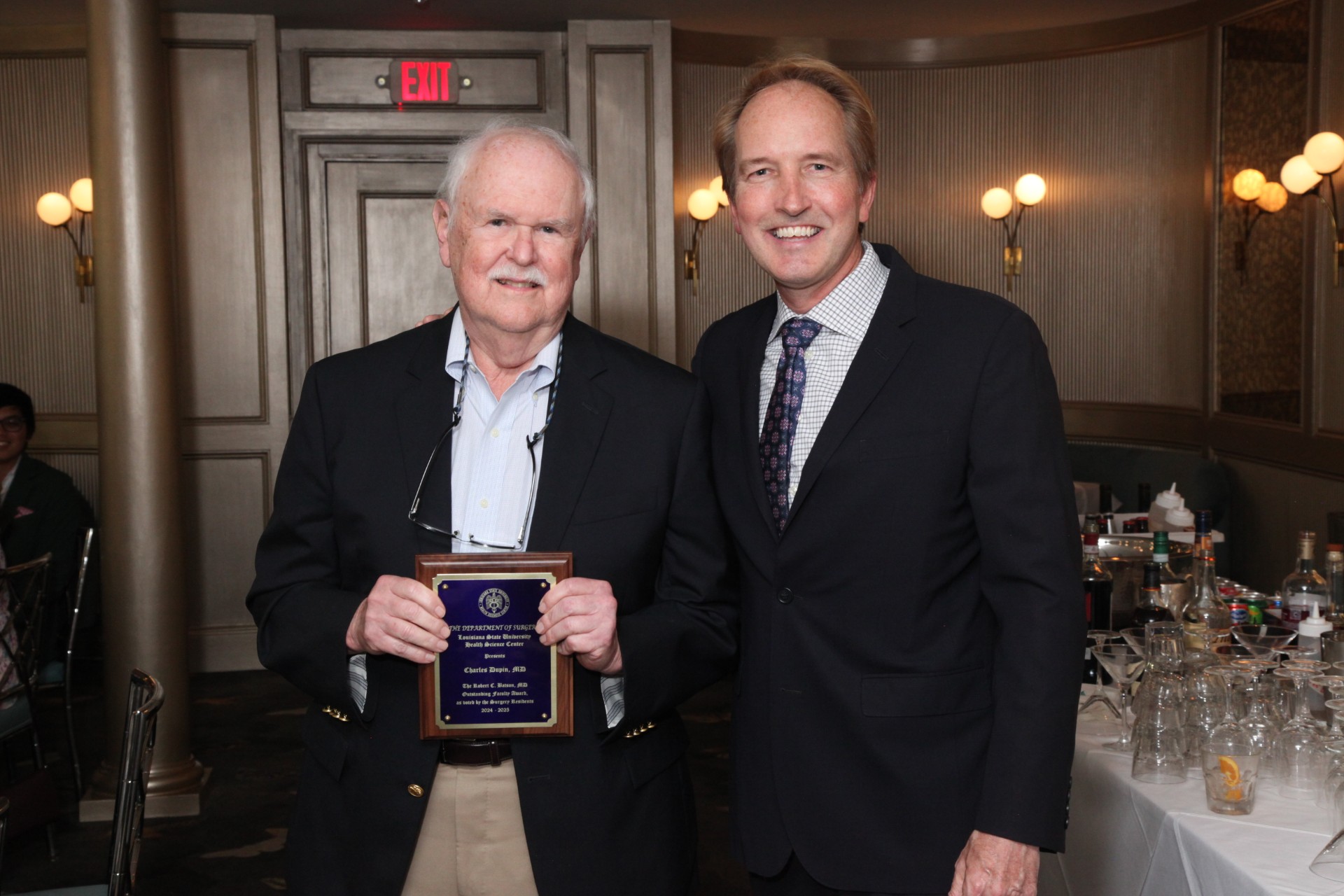Dr. Dupin holds award