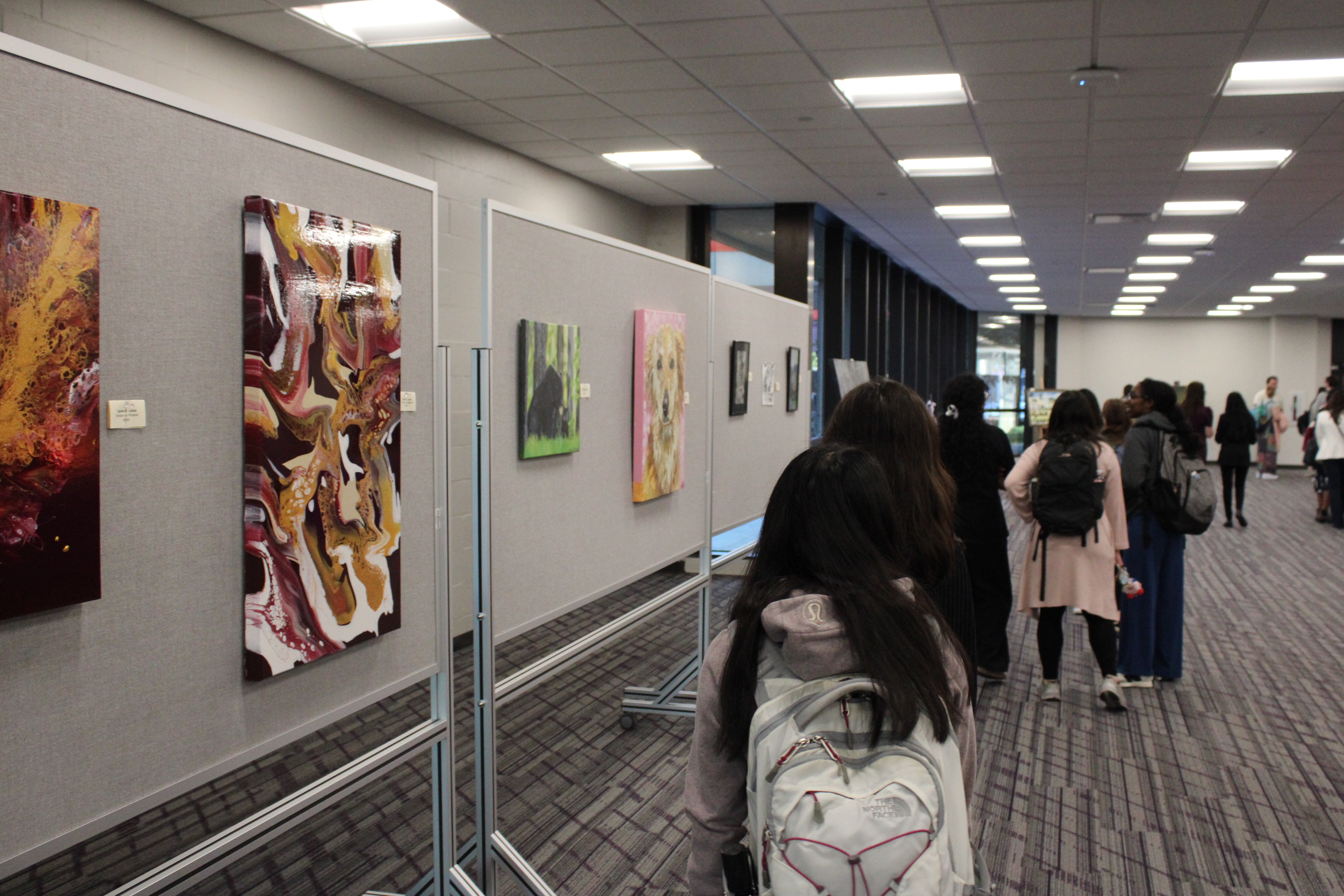 People walk past exhibit