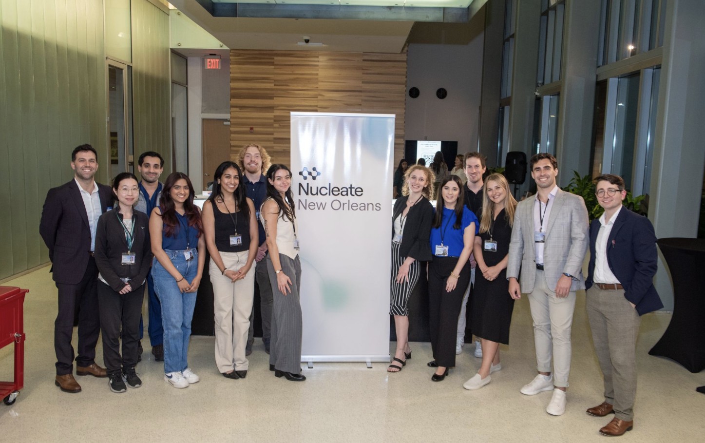 Nucleate X NOBIC leaders and participants pose around conference banner.